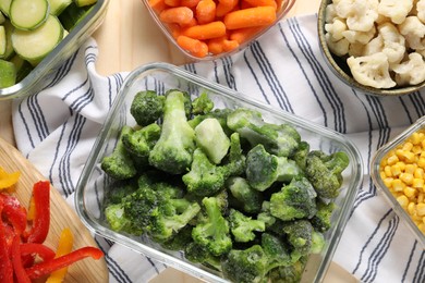 Photo of Different frozen vegetables on wooden table, top view