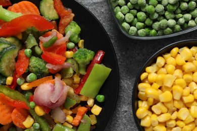 Photo of Different frozen vegetables on grey table, top view