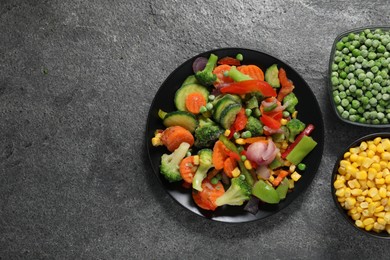 Photo of Different frozen vegetables on grey table, top view. Space for text