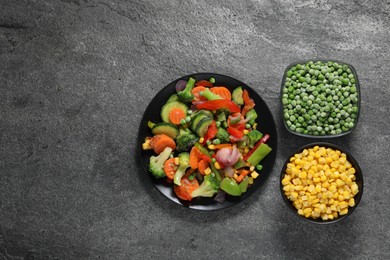 Photo of Different frozen vegetables on grey table, top view. Space for text