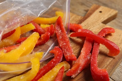 Photo of Slices of frozen bell peppers on table, closeup