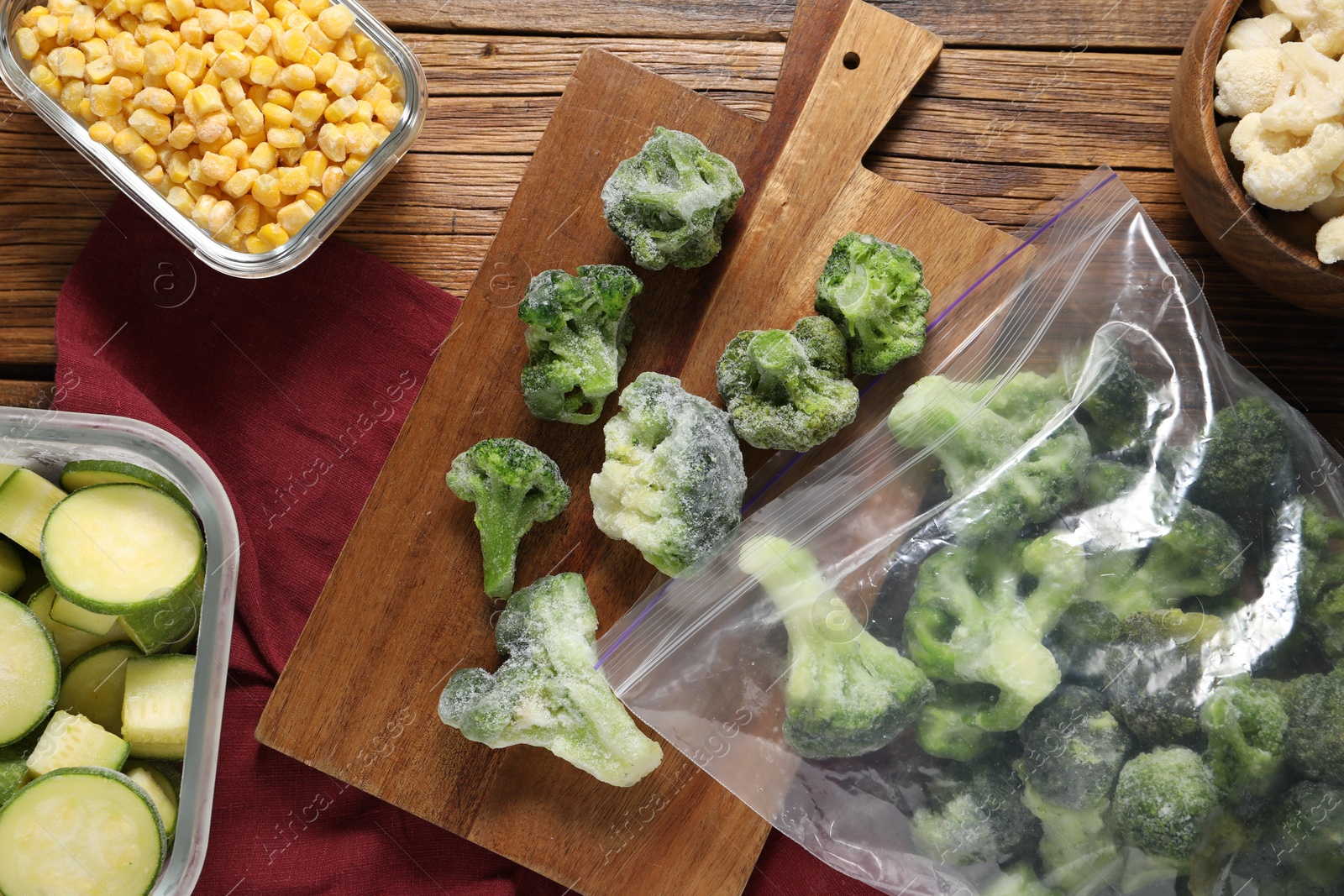 Photo of Different frozen vegetables on wooden table, top view