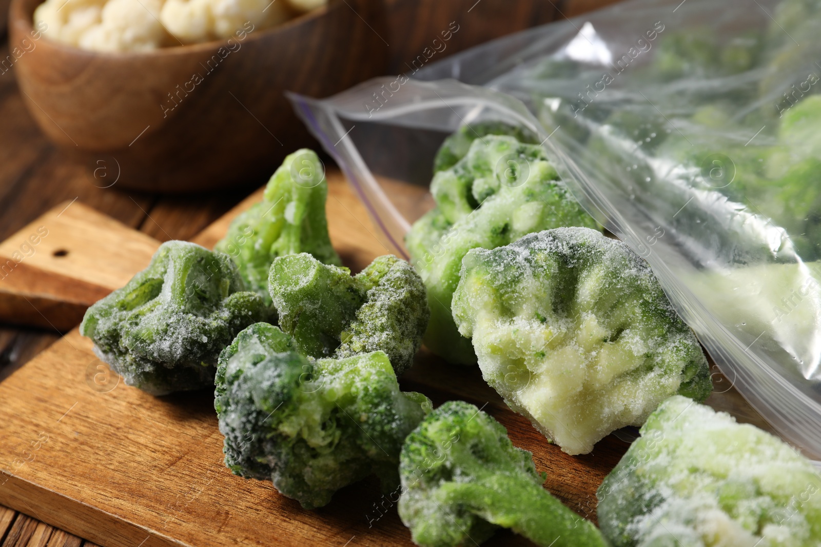 Photo of Frozen broccoli out of plastic bag on table, closeup