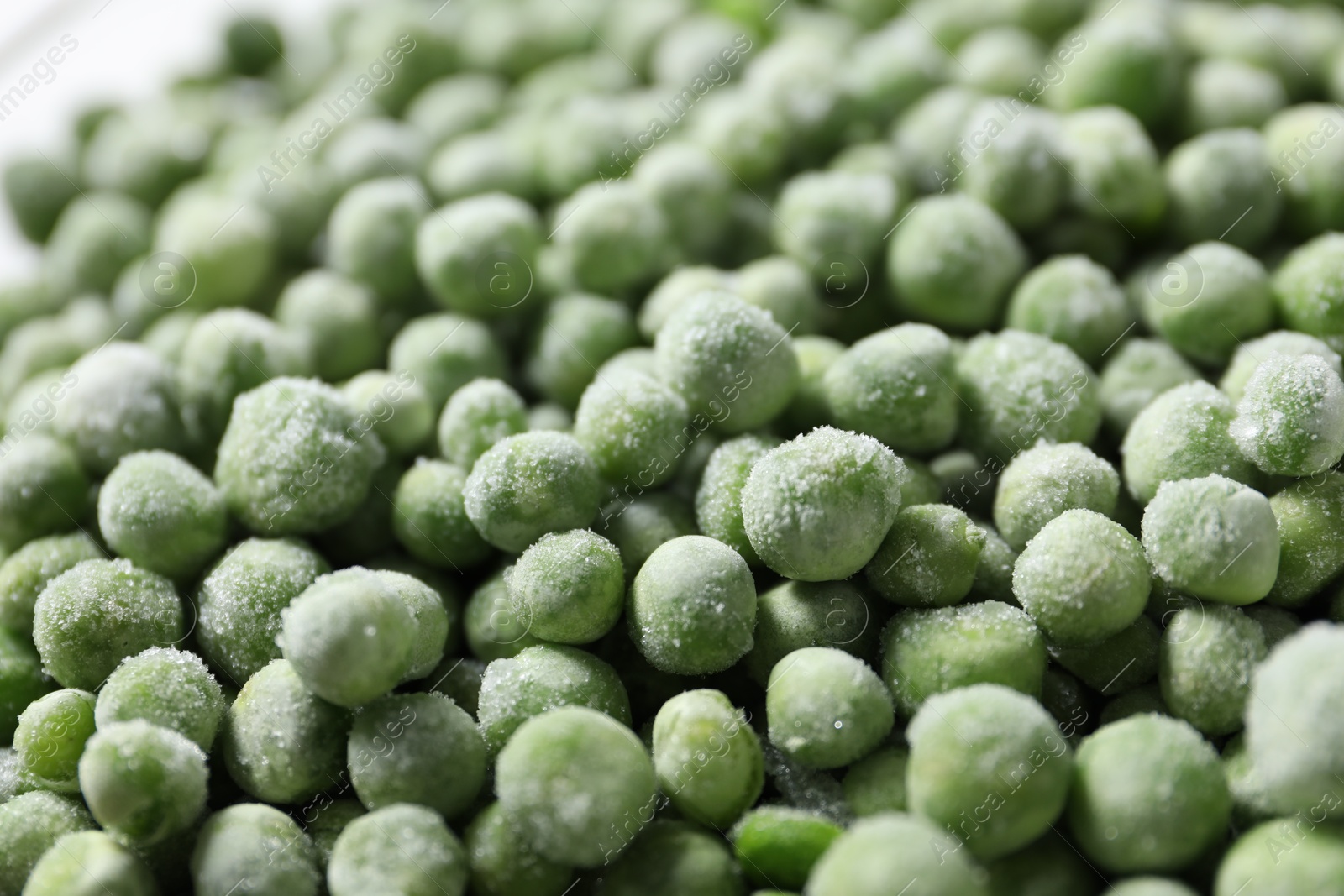 Photo of Frozen green peas as background, closeup view