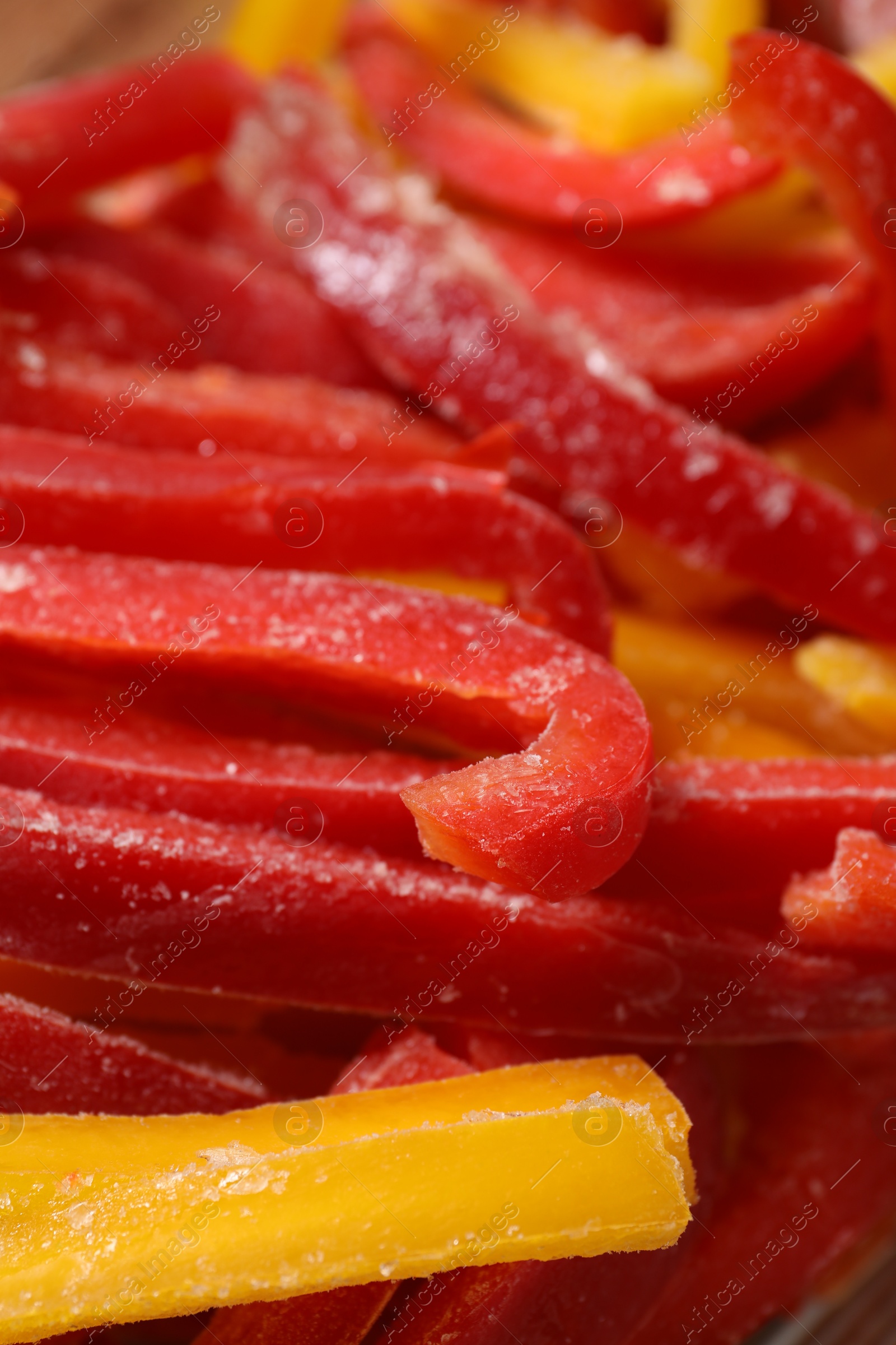 Photo of Slices of frozen bell peppers as background, closeup