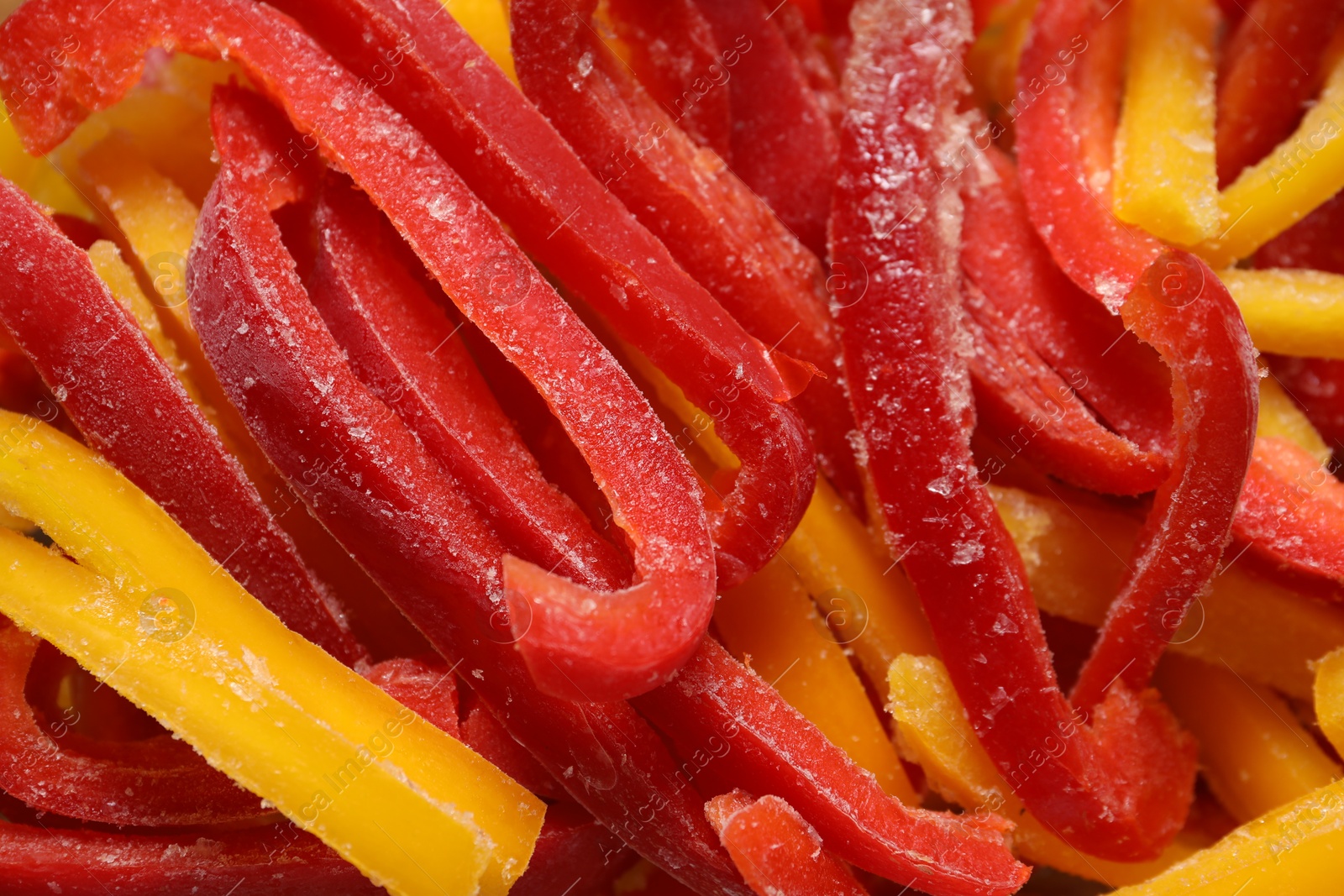 Photo of Slices of frozen bell peppers as background, closeup