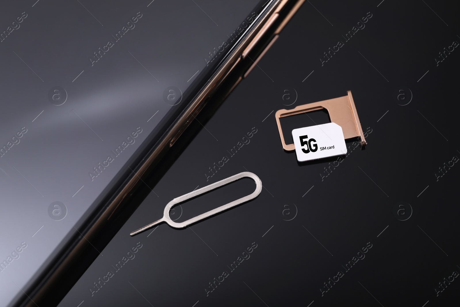 Image of 5G SIM card, smartphone and ejector on black background, above view