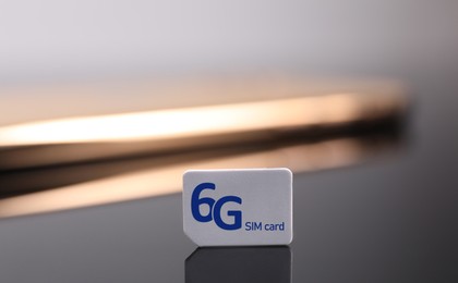 6G SIM card on dark background, closeup