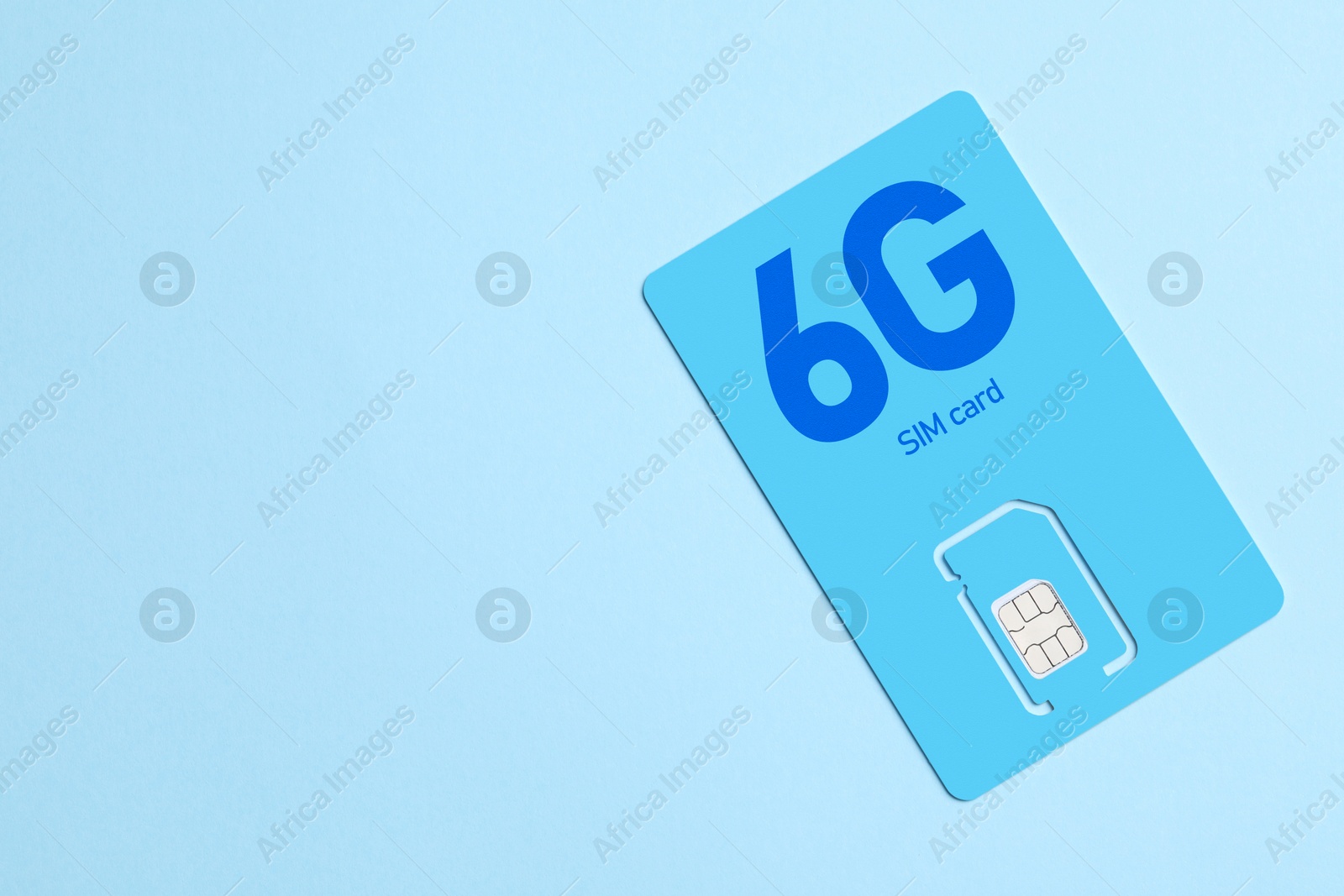 Image of 6G SIM card on light blue background, space for text