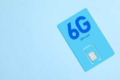 6G SIM card on light blue background, space for text