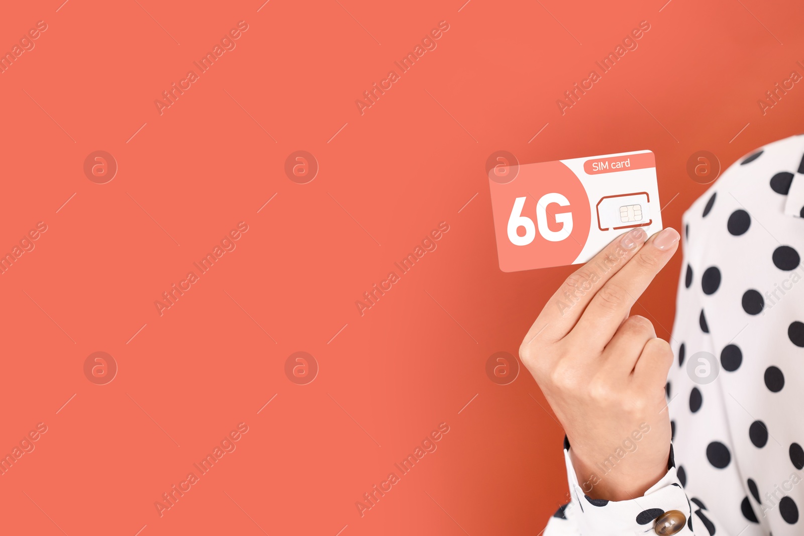 Image of Woman holding 6G SIM card on terracotta background, closeup. Space for text