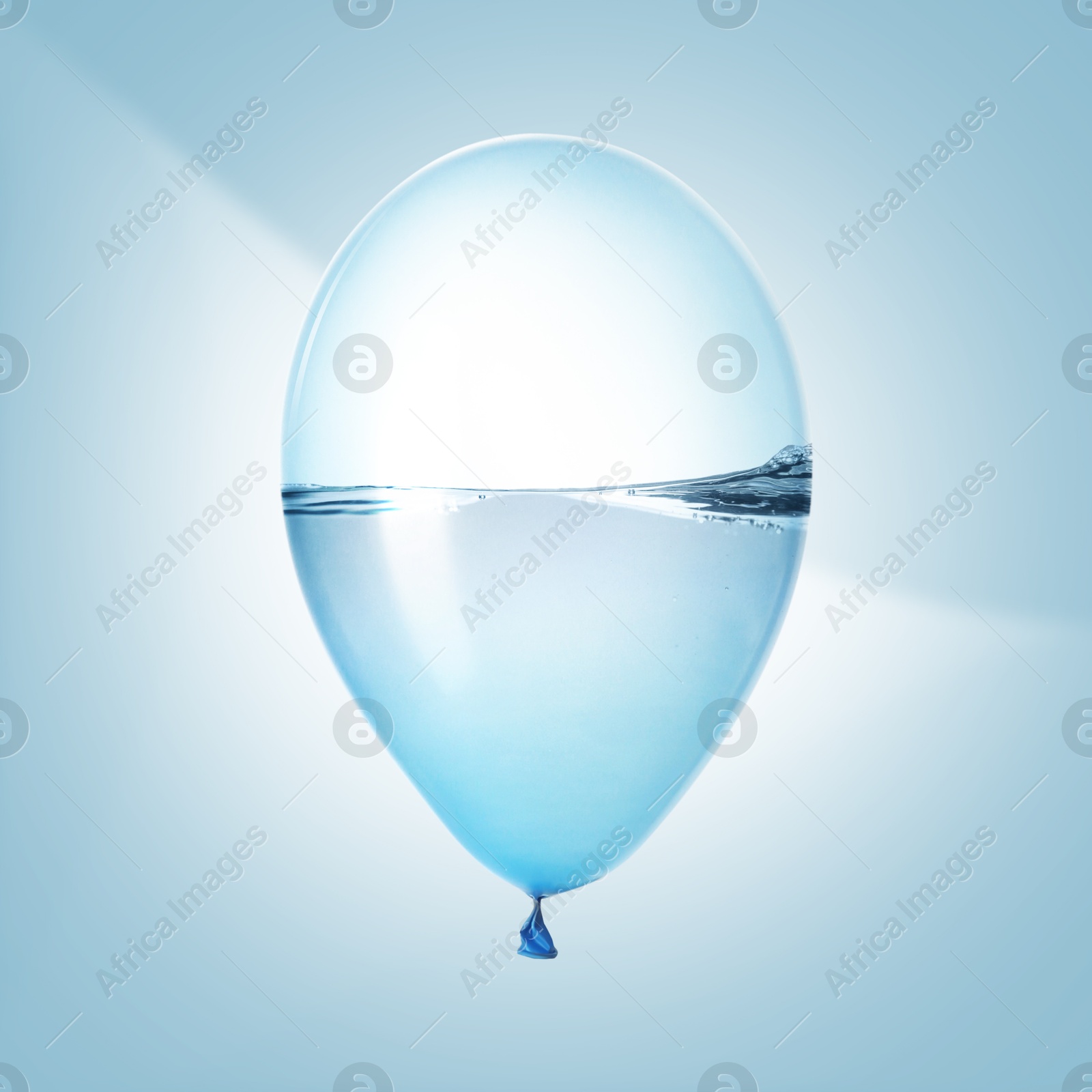 Image of Balloon with water inside on light blue background