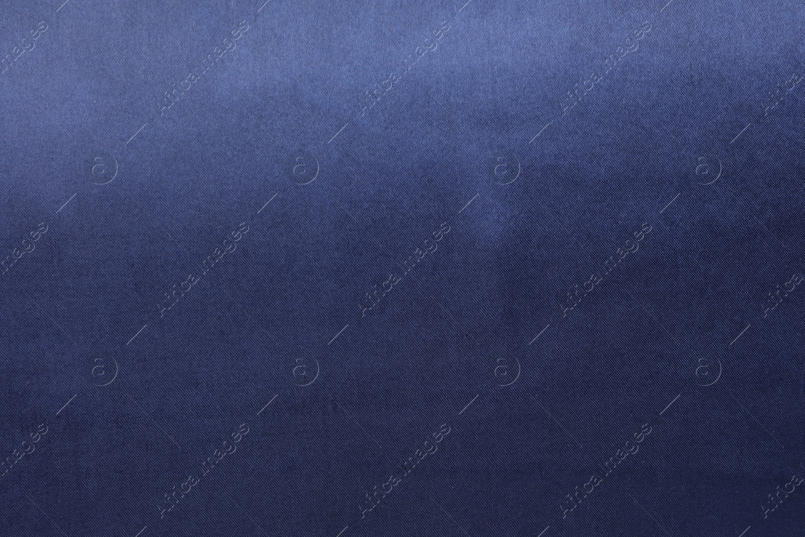 Photo of Texture of dark blue silk fabric as background, top view