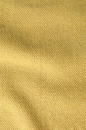 Photo of Texture of golden color fabric as background, top view