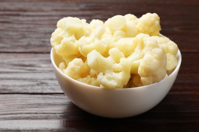 Photo of Tasty cooked cauliflower on wooden table, closeup