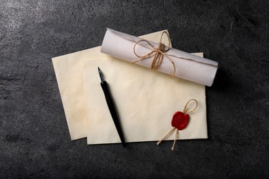 Photo of Old letters and fountain pen on grey table, top view