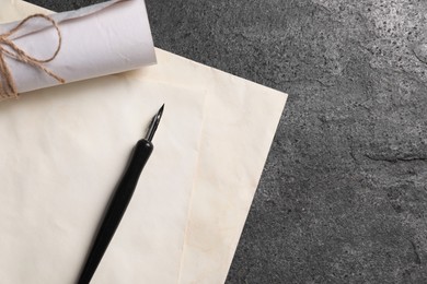 Photo of Old letters and fountain pen on grey table, top view. Space for text