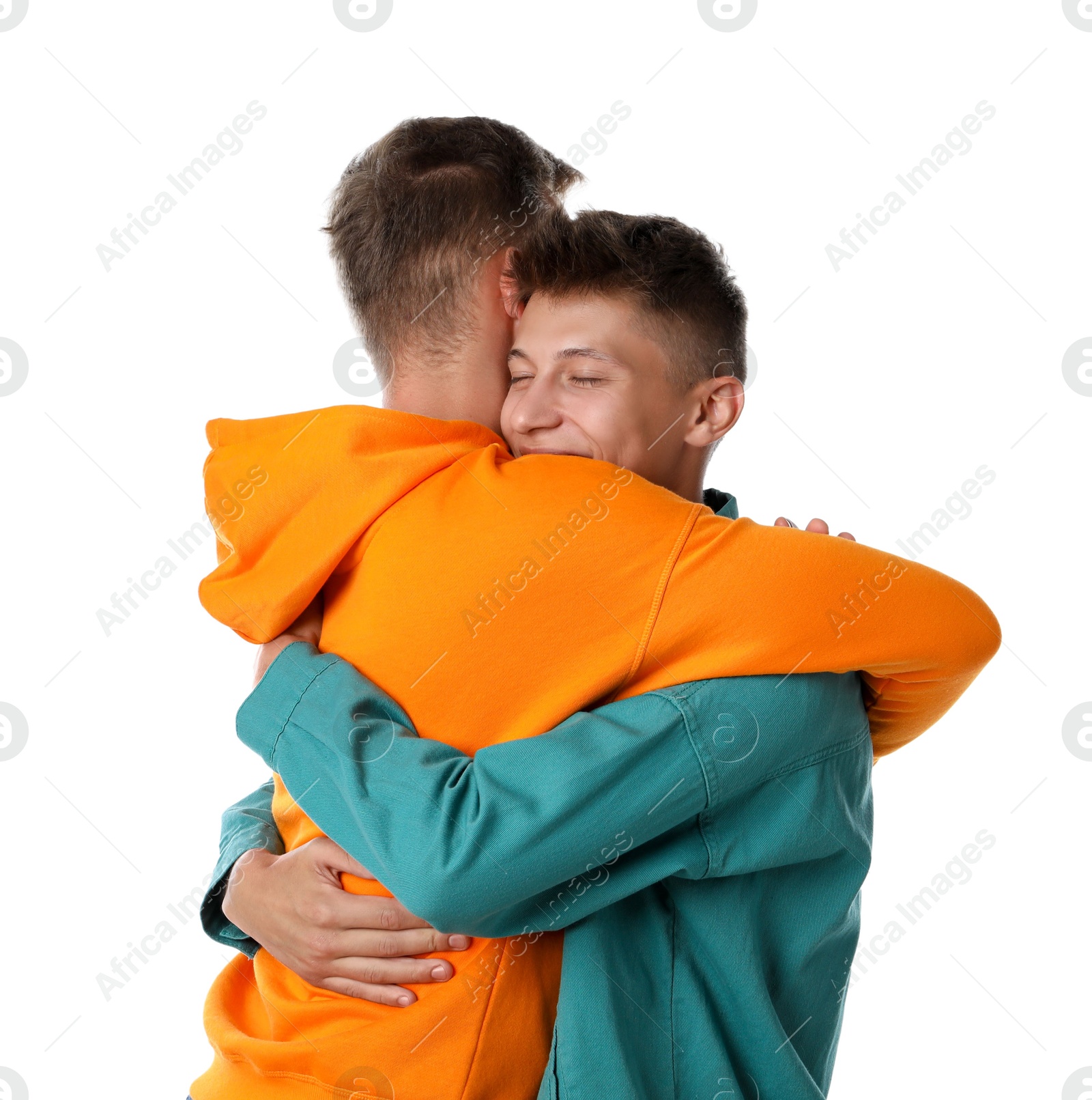 Photo of Two young brothers hugging on white background