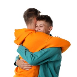 Photo of Two young brothers hugging on white background