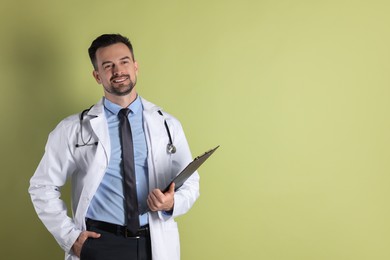 Photo of Smiling doctor with stethoscope and clipboard on olive background, space for text