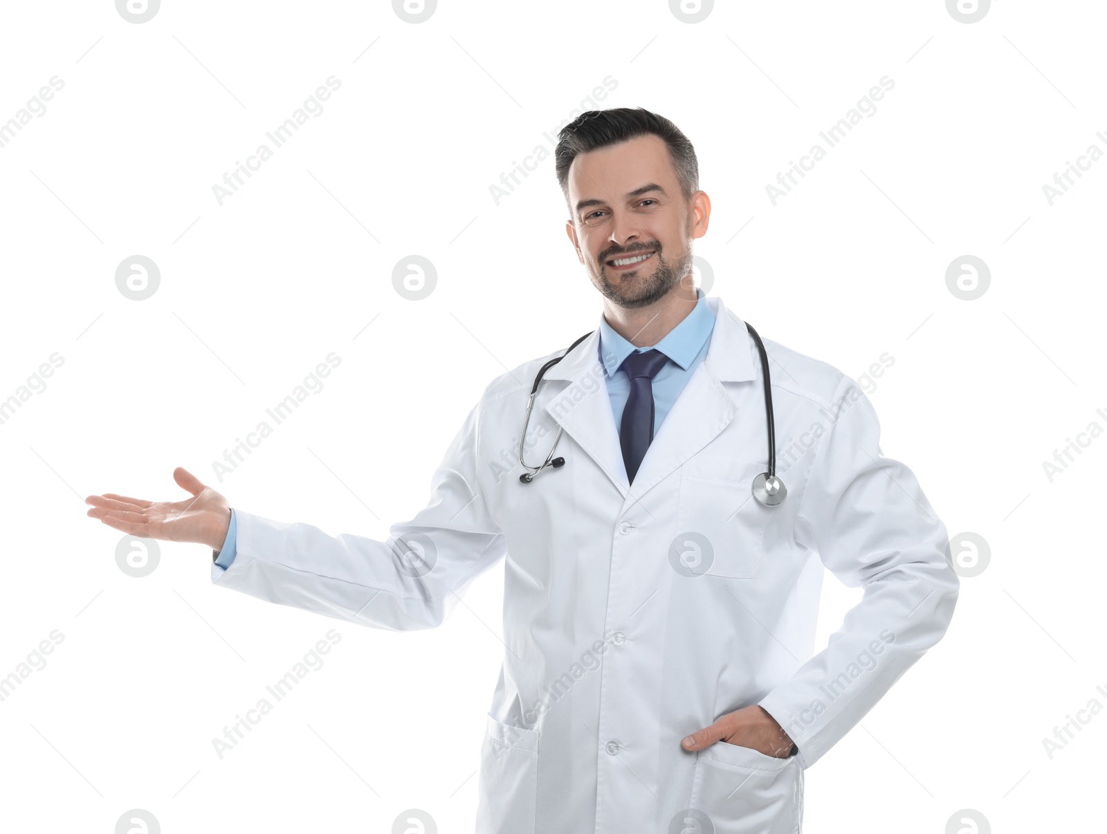 Photo of Smiling doctor with stethoscope pointing at something on white background