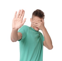 Portrait of scared young man on white background