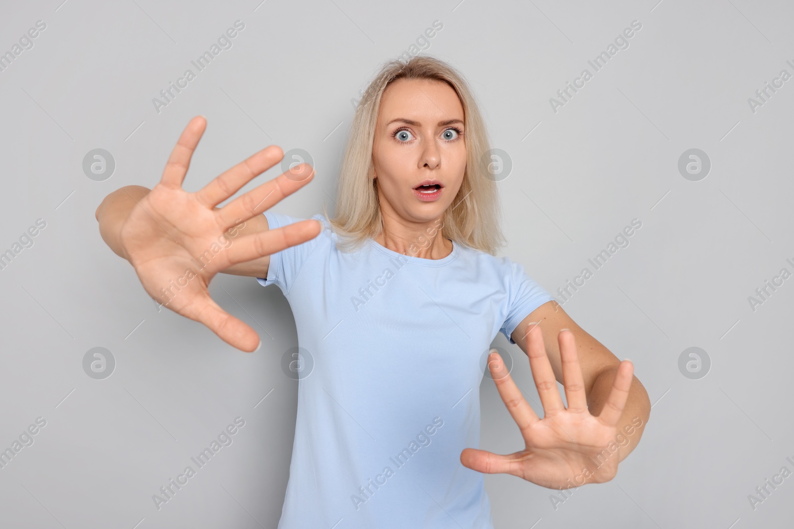 Photo of Portrait of scared woman on gray background