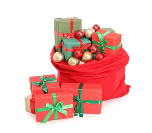 Photo of Santa Claus bag full of presents and decorative balls isolated on white