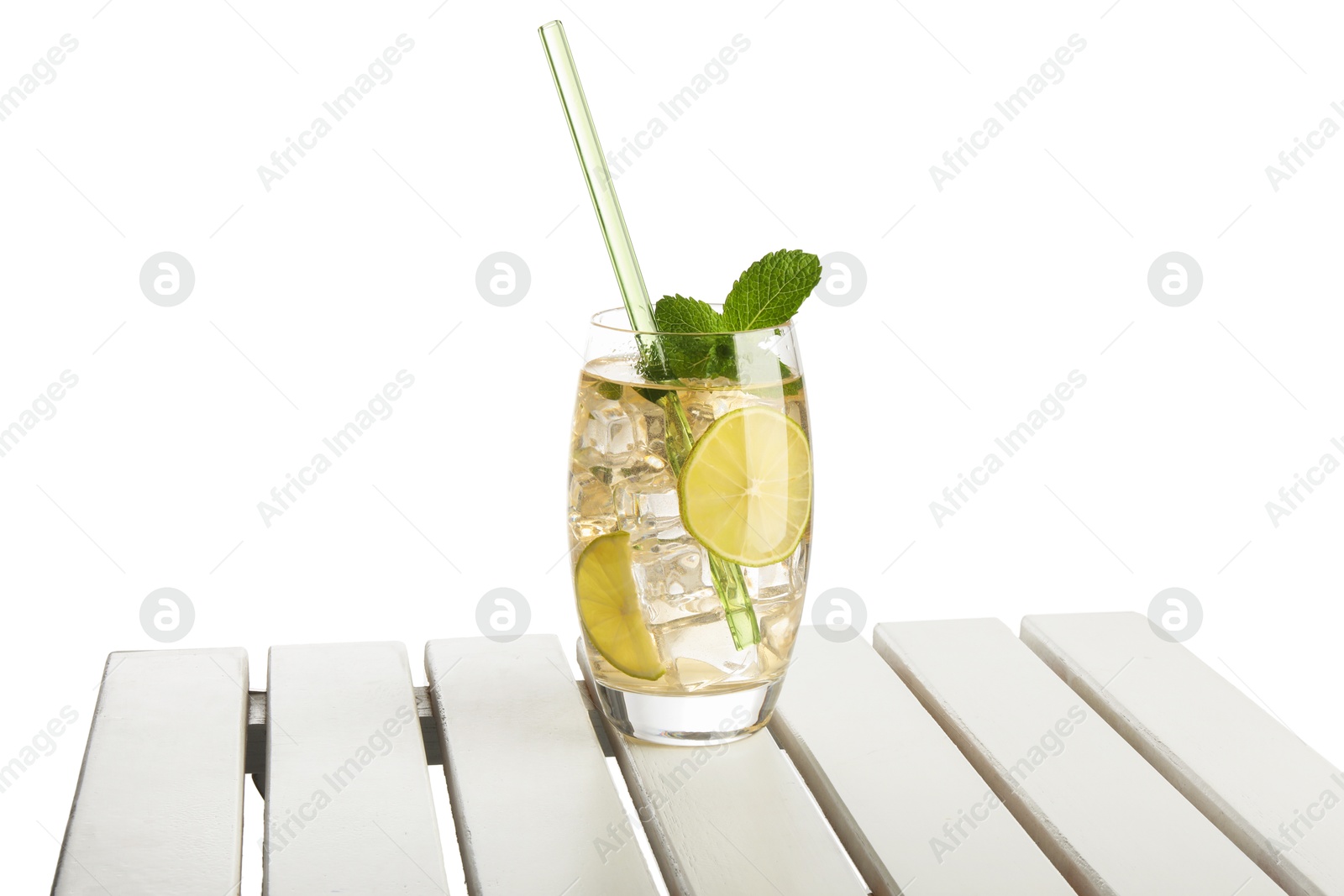 Photo of Glass of tasty refreshing drink and straw on wooden table against white background