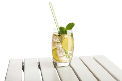 Photo of Glass of tasty refreshing drink and straw on wooden table against white background