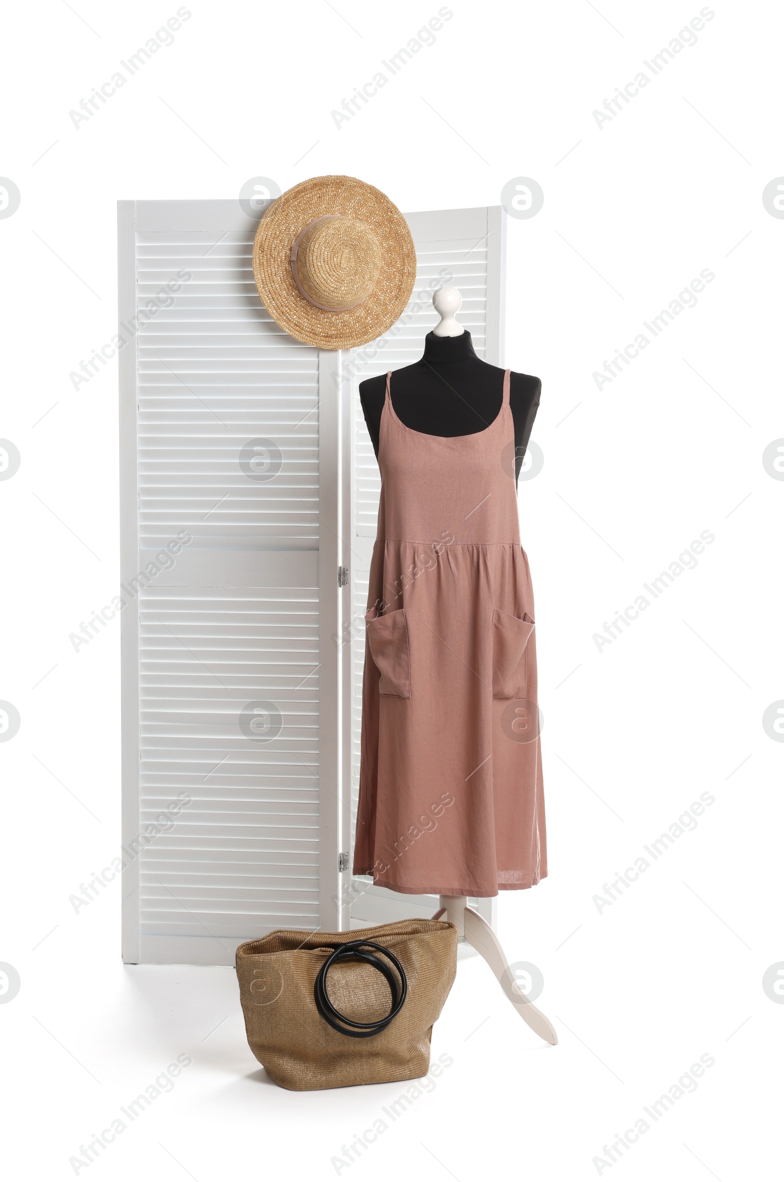 Photo of Female mannequin with stylish dress, straw hat and bag against white background