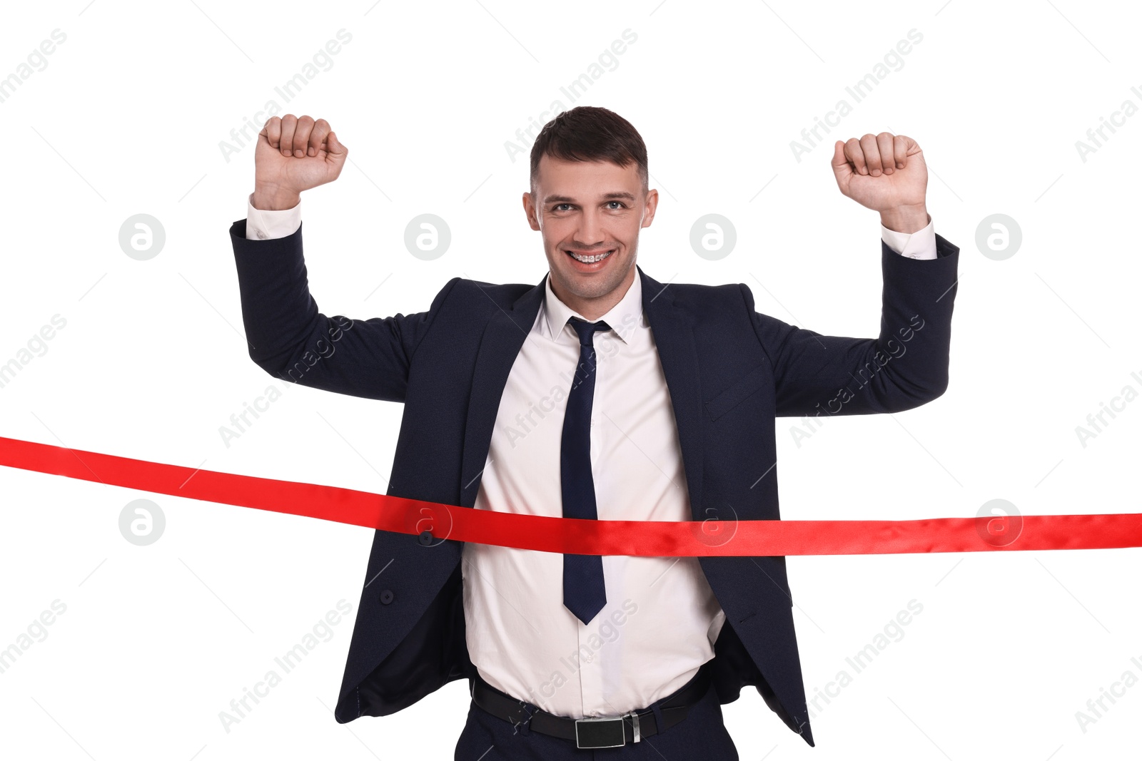 Photo of Businessman in suit crossing red finish line on white background