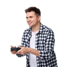 Young man playing video games with controller on white background