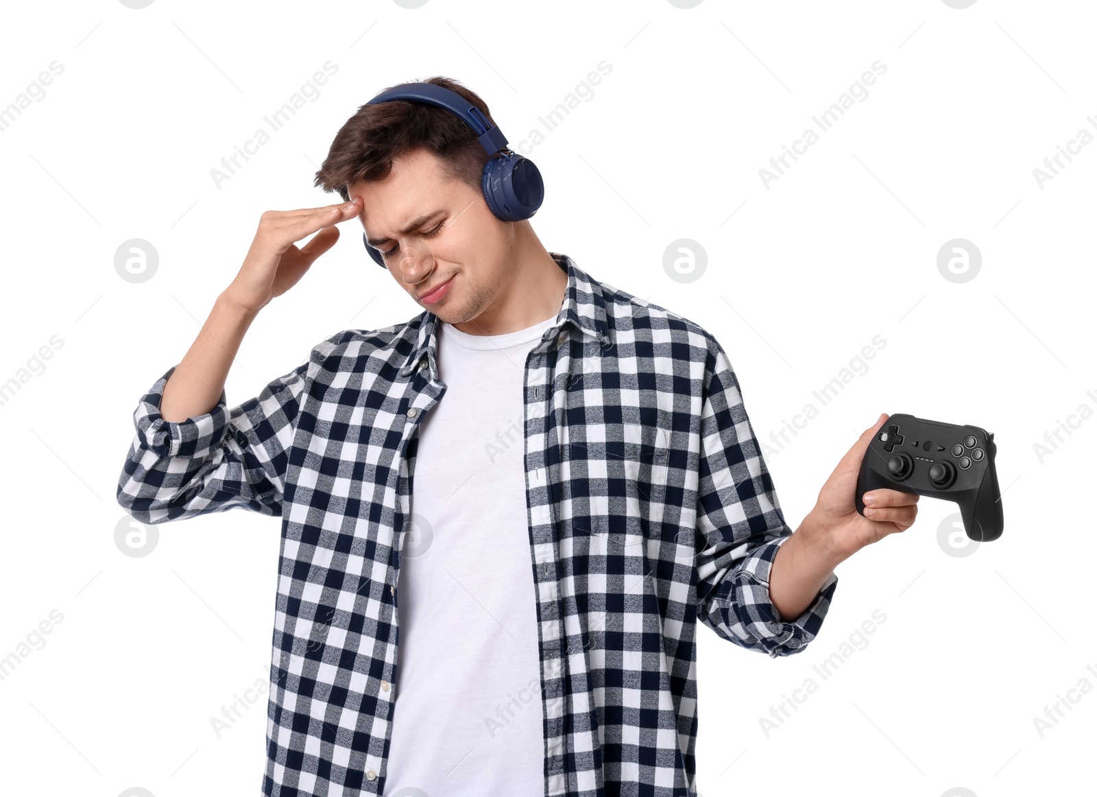 Photo of Young man in headphones with controller on white background