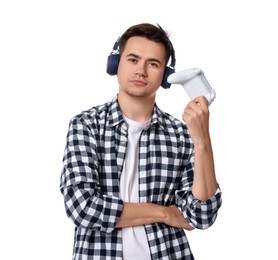 Young man in headphones playing video games with controller on white background