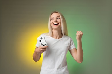 Happy woman with controller on color background