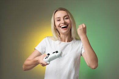 Happy woman with controller on color background