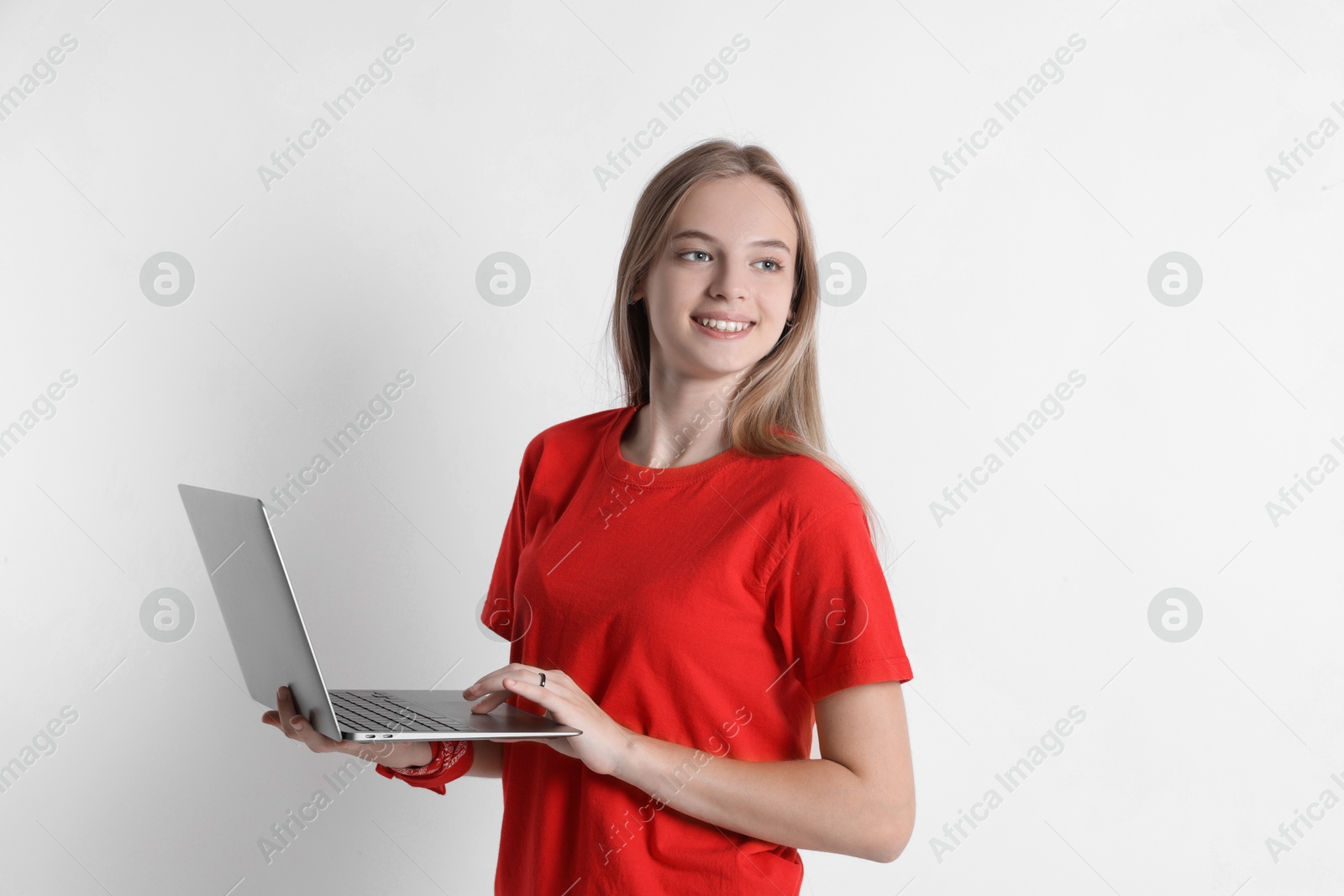 Photo of Teenage girl using laptop on white background