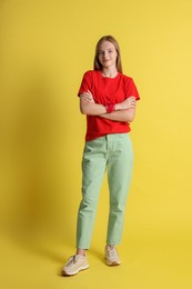 Photo of Full length portrait of teenage girl on yellow background