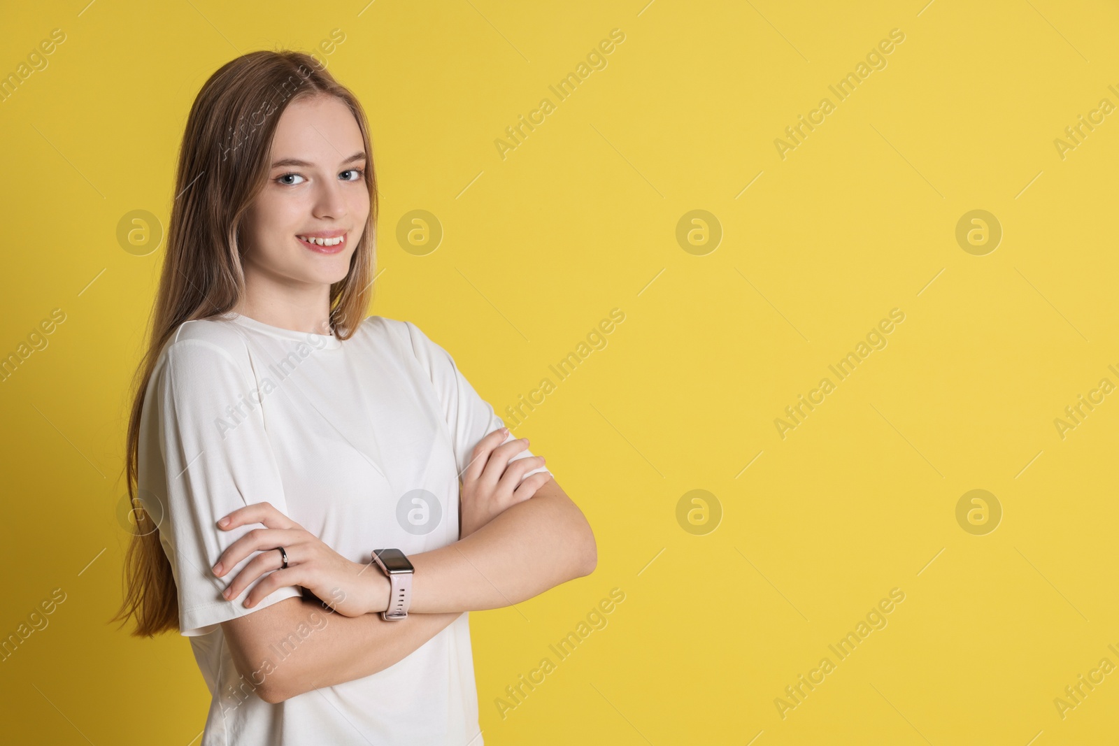 Photo of Portrait of teenage girl on yellow background, space for text