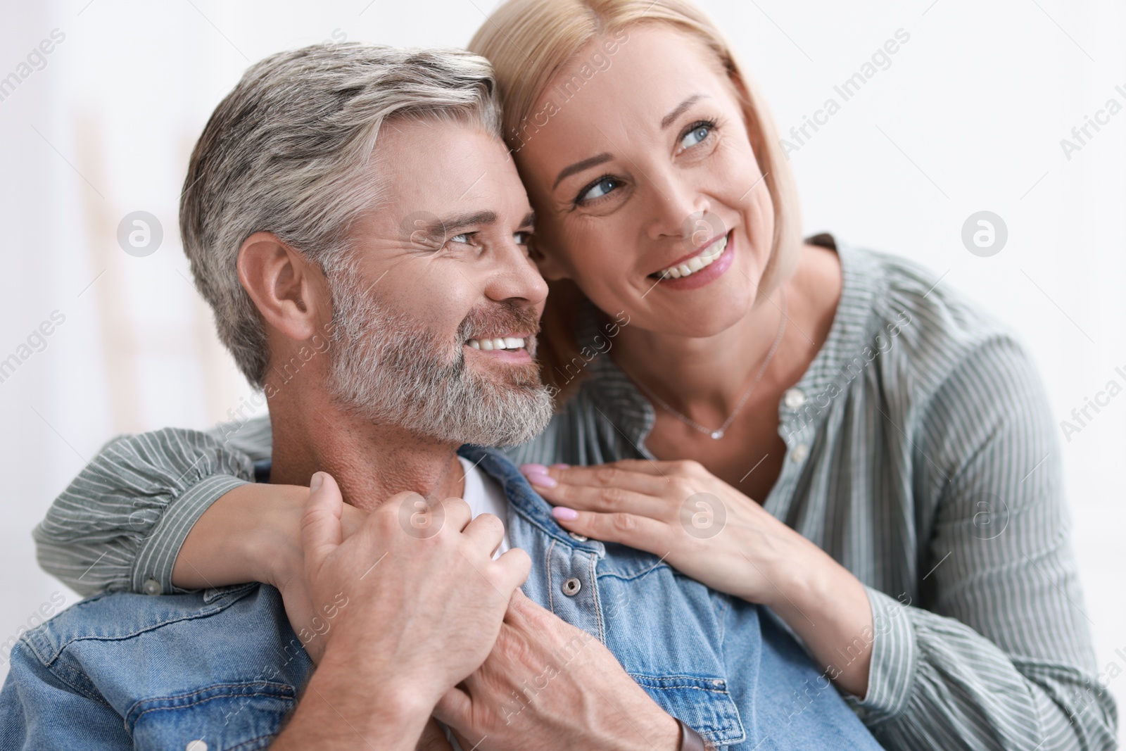 Photo of Portrait of happy middle aged couple indoors