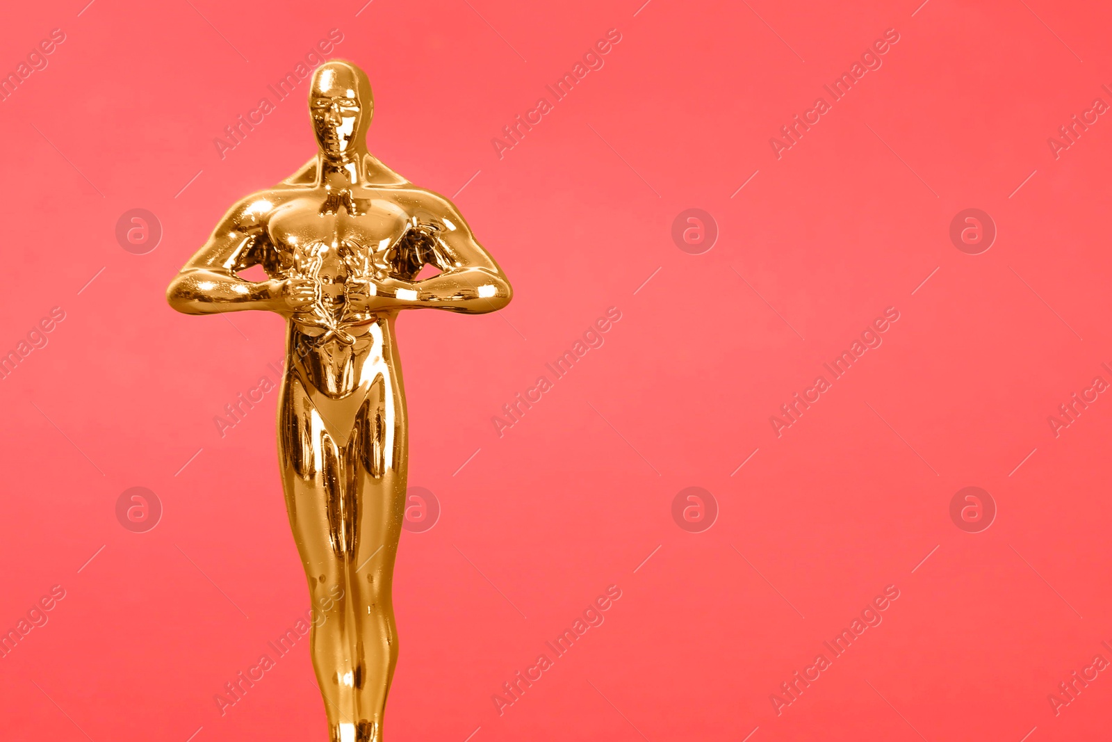 Photo of Golden trophy in shape of human figure on red background, space for text