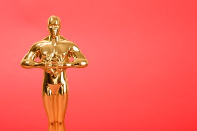 Photo of Golden trophy in shape of human figure on red background, space for text