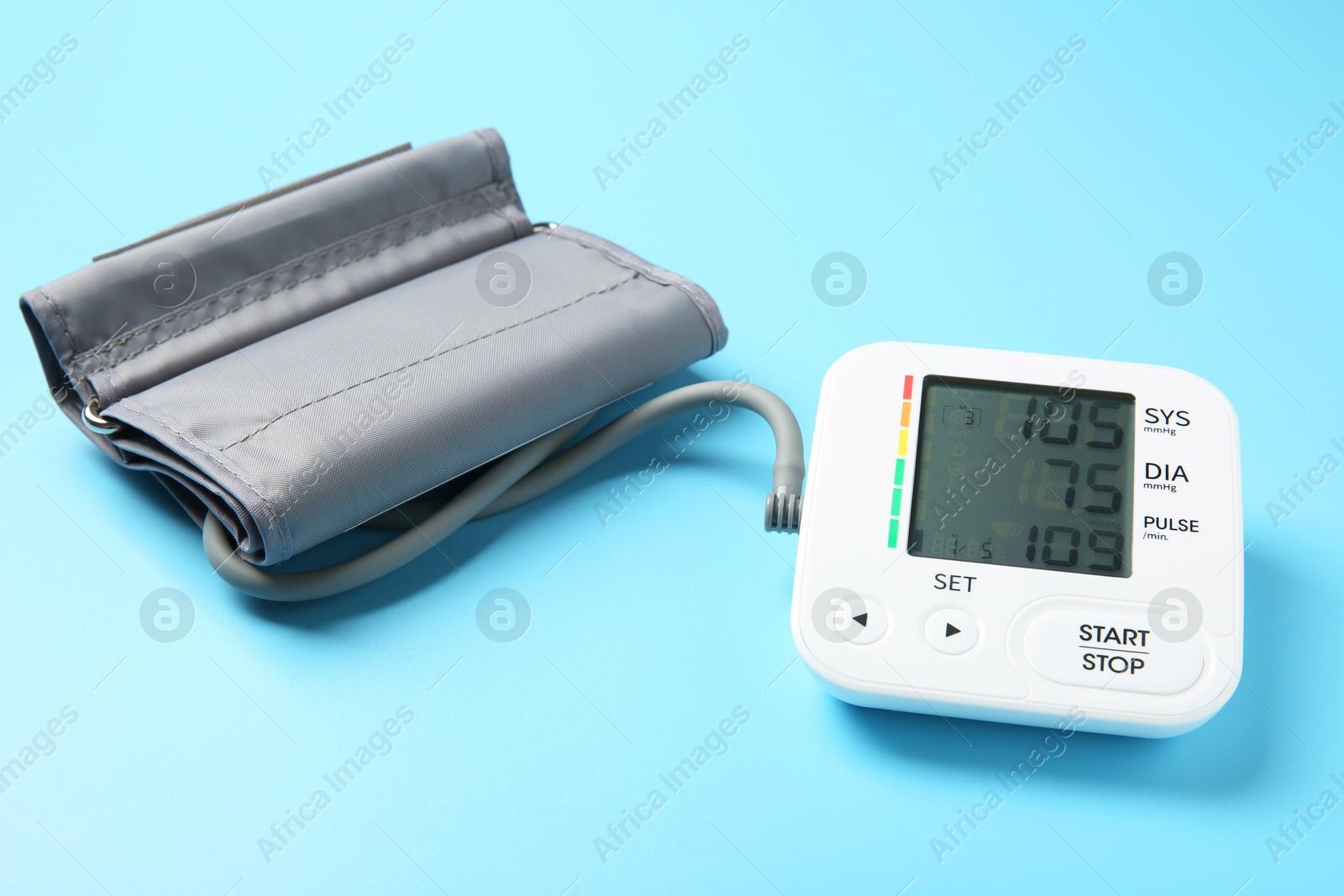 Photo of Blood pressure measuring device on light blue background