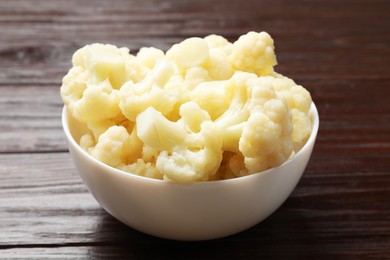 Photo of Tasty cooked cauliflower on wooden table, closeup