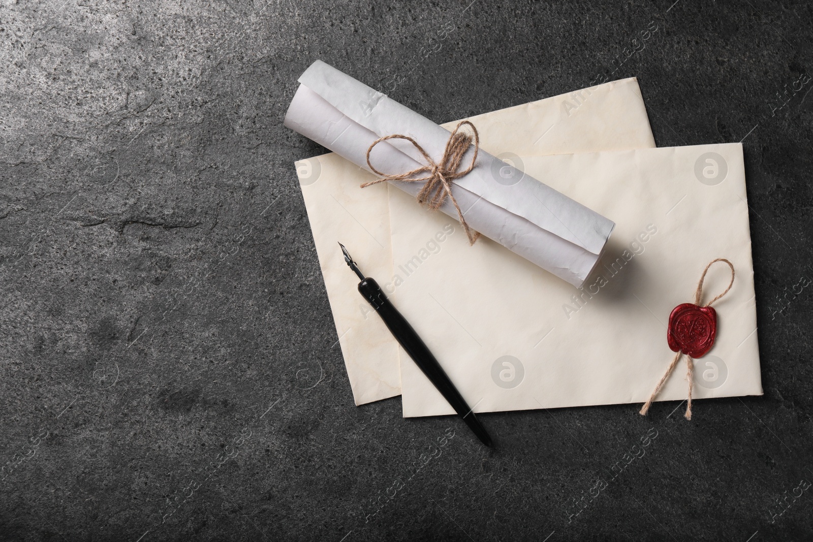 Photo of Old letters and fountain pen on grey table, top view. Space for text