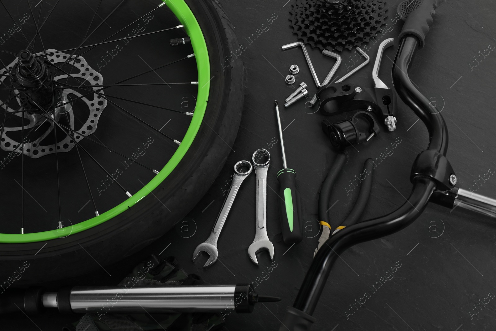 Photo of Parts of bicycle and tools on black background