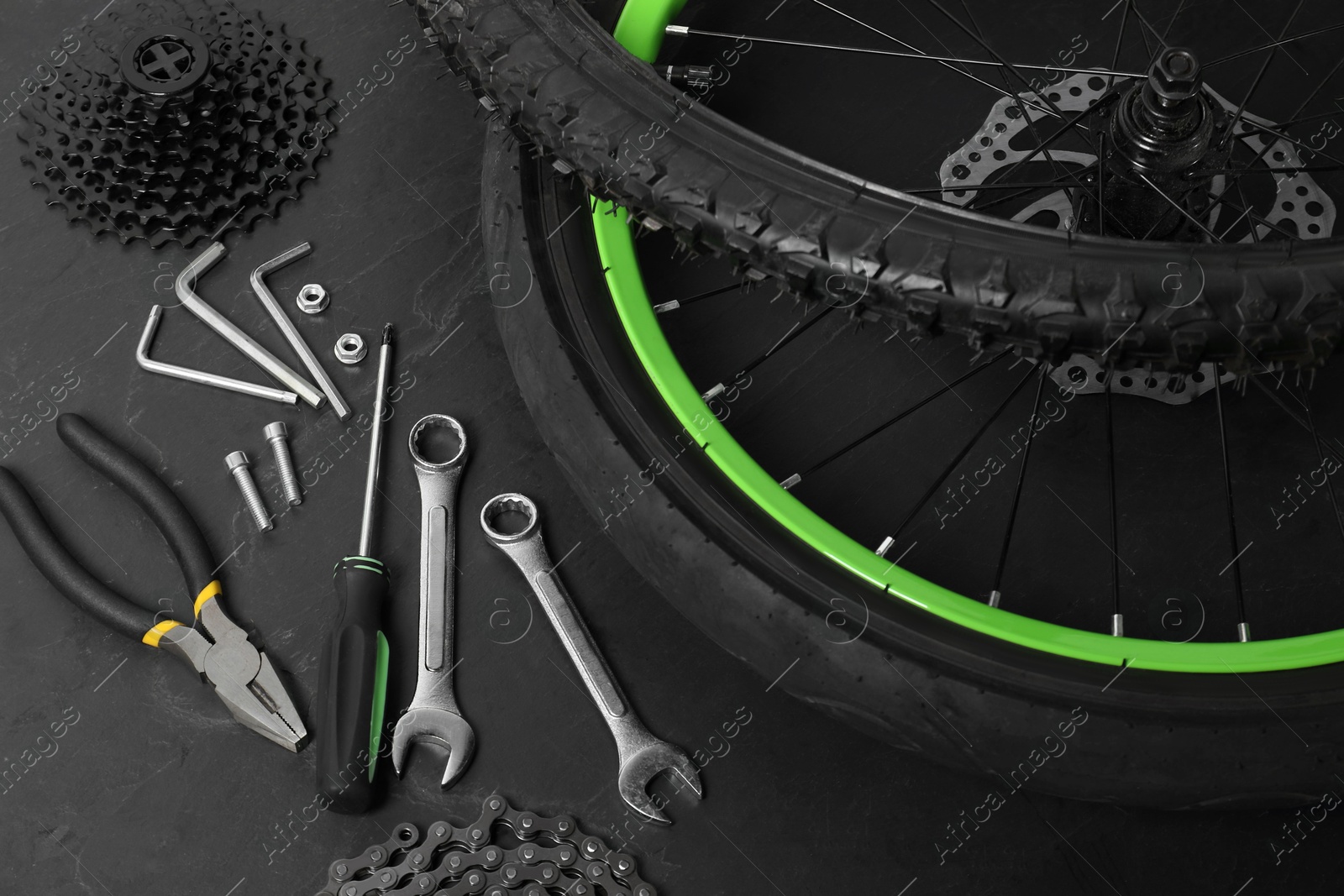 Photo of Parts of bicycle and tools on black background