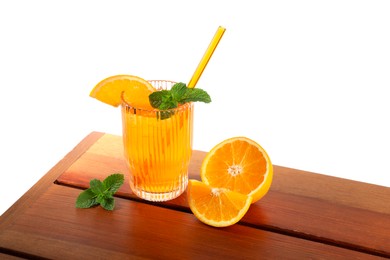 Glass of tasty refreshing drink with straw and fresh fruit on wooden table against white background