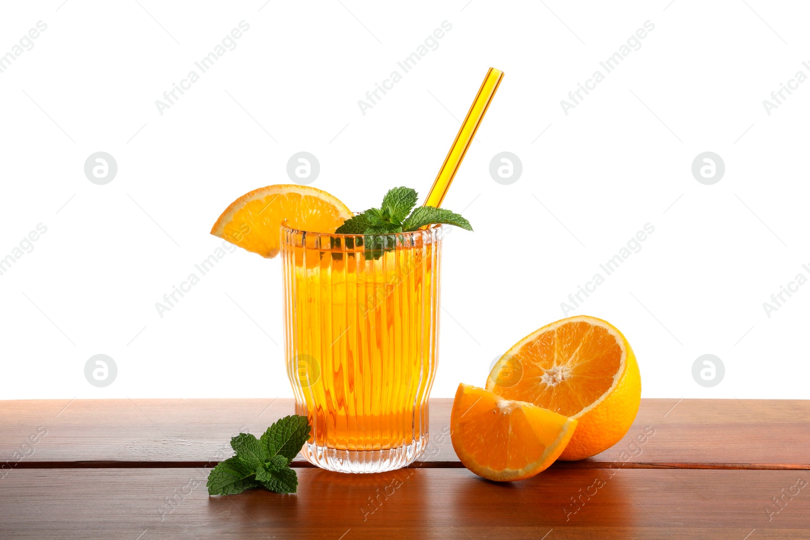 Photo of Glass of tasty refreshing drink with straw and fresh fruit on wooden table against white background